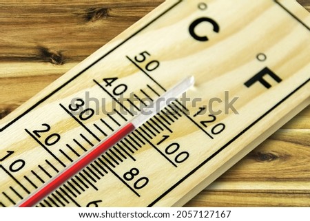 Thermometer Fahrenheit 100 close up on wooden background

