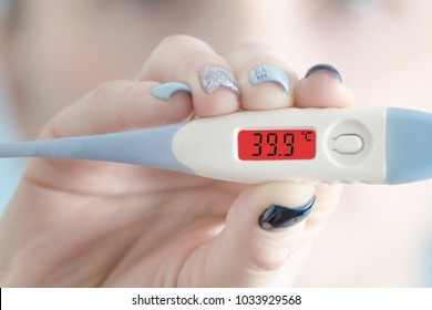 Thermometer In Female Hand. Hyperthermia. Face On Background