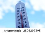 Thermometer for measuring outdoor air temperature. Meteorological device for observing and measuring the weather. Weather forecast. Thermometer on blue sky background. Hot weather, drought in summer.