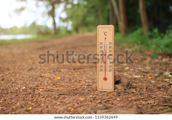 thermometer on dirt road with hot temperature at\
environment in\
Thailand