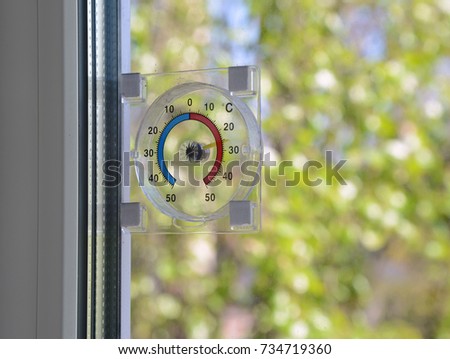 Thermometer on the window. Summer background