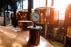 Thermometer Or Pressure Gauge On Copper Colored Brewery Tanks Close Up.