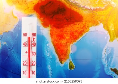 Thermometer With A Record High Temperature Of Fifty Degrees Celsius, Against The Backdrop Of The Continent Of The Indostan Subcontinent. Hot Weather Concept