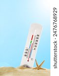 Thermometer In Sand With Starfish On Sunny Day