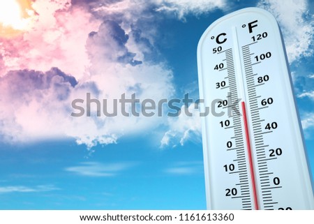 Thermometer show temperature at 20 degree Celsius in bright blue sky