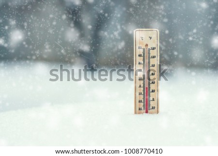 The thermometer in the snow, shows the temperature of Zero during the time of the Snow Storm. Winter. Snow storm. Snowfall.