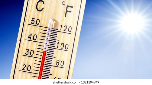 Thermometer in summer day shows or indicate high temperature degree with sun in background.