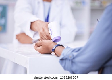 Thermometer, temperature check and hands of people at a pharmacy for healthcare, service or inspection. Medical, clinic and a pharmacist with a customer and gear for a virus test or exam in a store - Powered by Shutterstock