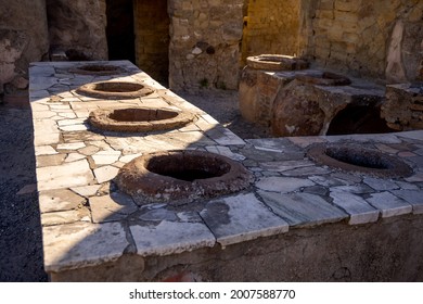 Thermopolium Or Taberna (cook-shop) In Ercolano - Herculaneum, Ancient Roman Town Destroyed By The Eruption Of The Mount Vesuvius Or Vesuvio Volcano. Ancient Pottery, Ceramics Of Fast Food Shop. 