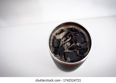 A Thermos Of Iced Coffee And Ice Cubes Shot From Above.