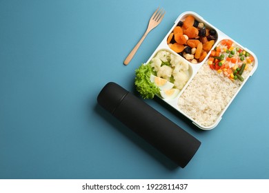 Thermos And Lunch Box With Food On Light Blue Background, Flat Lay. Space For Text