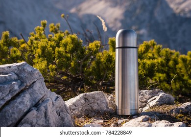 Thermos Vacuum flask in the mountains