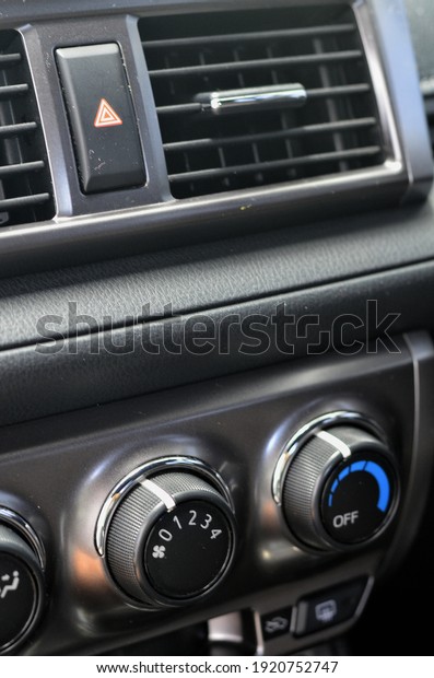 Thermostat and air conditioner fan speed dial\
on a car dashboard.