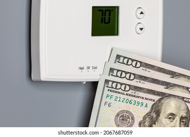 Thermostat for home furnace and air conditioner. Utility bill savings, energy cost and conservation concept - Shutterstock ID 2067687059