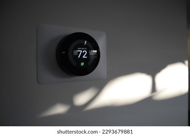 Thermostat in a house at sundown