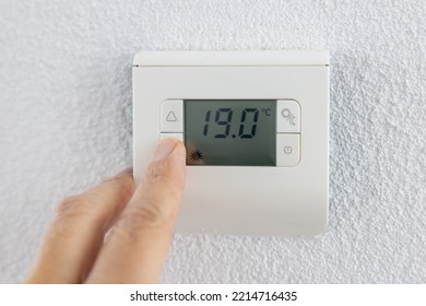 Thermostat is manually lowered to a temperature of 19 degrees Celsius. - Shutterstock ID 2214716435