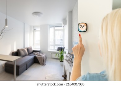 Thermostat Smart Home Domotic Control Panel On Wall For Winter House Temperature Banner Panoramic. Energy Saving Hand Touching To Adjust Temperature Of Heating In Living Room.