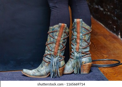 These boots were made for walking, an image of country western wear cowgirl boots worn by a young woman at a night club in downtown Nashville.