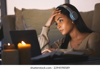 These deadlines creep up on you so fast. Cropped shot of an attractive young woman working late at night in her living room at home. - Powered by Shutterstock