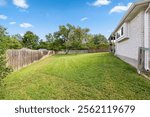 These real estate photos highlight a stunning backyard, featuring lush landscaping, vibrant gardens, and a spacious patio area. The outdoor space offers a perfect setting for relaxation and entertaini