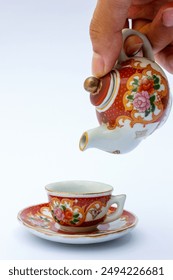 These tea sets typically include a teapot, cups, and sometimes saucers, all adorned with vibrant floral motifs.