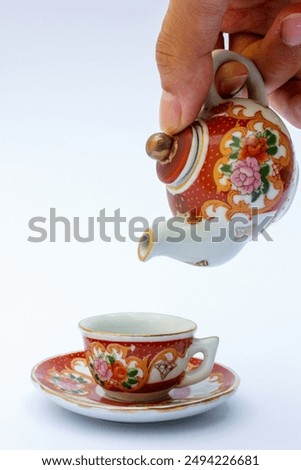 These tea sets typically include a teapot, cups, and sometimes saucers, all adorned with vibrant floral motifs.