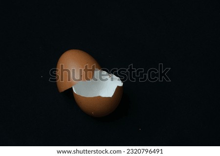 These are two egg shells that are photographed in the dark