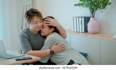 These Two Women Were Lovers, The Short-haired Woman Sat Hugging The Long-haired Woman, On The Chair At The Desk,His Lover Was Begging Him, The Love, And Friendship Of LGBTQ Couples.