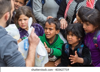 Thessaloniki, Greece - April 2, 2016: Refugees Living In Tents At The Relocation Center Diavata Waiting In Line To Get Food