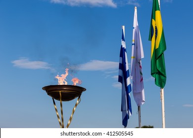 Thessaloniki, Greece - April 23, 2016: The Olympic Flame and the flags of the Olympics, Brazil and Greece. Arrival of the Olympic Flame of XXXI Summer Olympic Games Rio 2016  in Thessaloniki