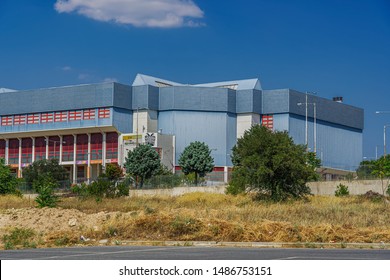 Thessaloniki, Greece - August 24 2019: P.A.O.K. B.C. Sports Arena Facade. External Side Day View Of PAOK Basketball Team Indoor Arena At Pylaia Area With Team Logo, Double-headed Black Eagle Visible.