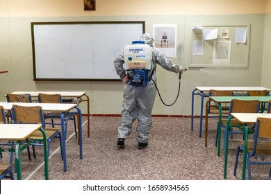 Thessaloniki, Greece - Feb 28, 2020: Workers sprays disinfectant as part of preventive measures against the spread of the COVID-19, the novel coronavirus, in a school 