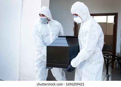 Thessaloniki, Greece - Mar. 31, 2020. Funeral Home Employees Wear Protective Suits To Protect Themselves From Coronavirus, As They Carry A Coffin.