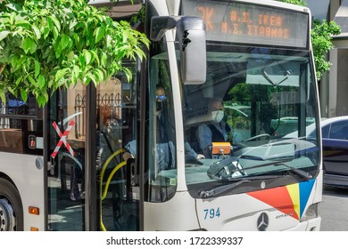 Thessaloniki, Greece - May 4 2020: Public Bus Driver Wearing COVID-19 Protective Mask. OASTH Public Transportation Vehicle At Stop Of Thessaloniki Urban Transport Organization In The City Centre.