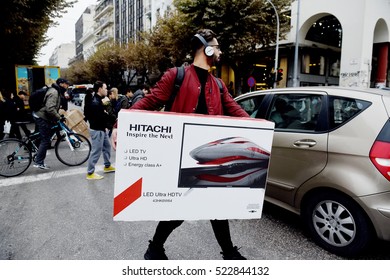 Thessaloniki, Greece - November 25, 2016. A Man Carries A TV After Buying It From A Department Store During Black Friday Shopping Deals, At The Northern Greek City Of Thessaloniki. 