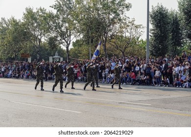 Thessaloniki, Greece - October 28 2019: Oxi Day Greek Army Personnel Parade Holding Flag. Hellenic Military March During National Day Celebration, With Attending Crowd.