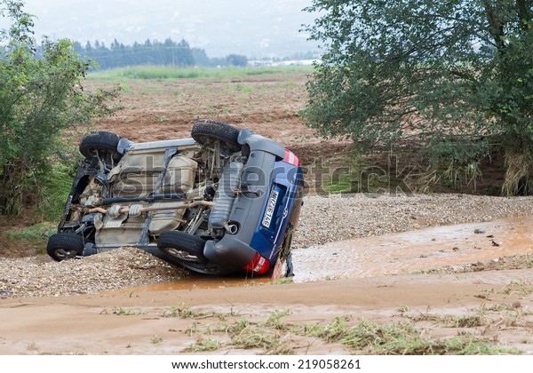 THESSALONIKI, GREECE- SEPTEMBER 15, 2014: Car\
overturned with one dead from the flood in Liti near Thessaloniki,\
Greece. Several main roads in Greece became flooded due to strong\
downpour.