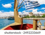 Thessaloniki view from boat. White Tower and Greek flag. Greece, Europe.