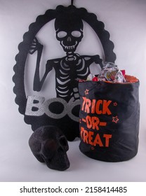 THETFORD, UNITED KINGDOM - Oct 05, 2020: A Spooky Skeleton Saying Boo And A Trick Or Treat Bag With A Black Skull