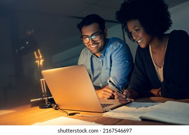 They always perform at their peak no matter the hour. Cropped shot of two colleagues working late on a laptop in an office. - Powered by Shutterstock