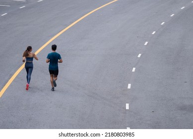 They Are An Asian Couple Jogging And Exercising.