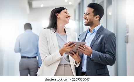 They Dont Just Survive Under Pressure, They Thrive. Shot Of Two Businesspeople Discussing Something On A Digital Tablet.