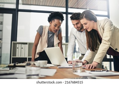 They have a strong sense of purpose. Shot of a team of businesspeople using a laptop together at work. - Shutterstock ID 2167684515