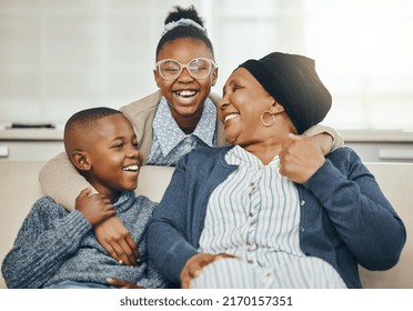 They Know How To Play. Shot Of A Grandmother Bonding With Her Grandkids On A Sofa At Home.