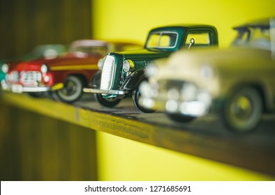 They Look Like Real Cars. Classic Model Vehicles Or Toy Vehicles. Miniature Collection Of Automobiles. Retro Car Models On Shelf. Retro Styled Cars. Toy Cars With Retro Design.