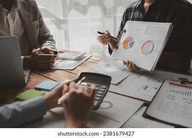 They are planning finances for expenses within the company, Meeting on reporting tax payments, Calculate the numbers according to the report sent to the meeting, finances idea. - Shutterstock ID 2381679427