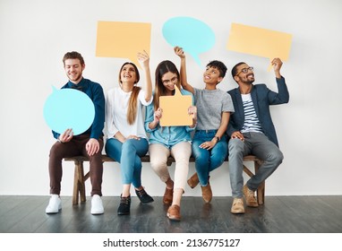 They are quite outspoken. Shot of a diverse group of creative employees holding up speech bubbles inside. - Shutterstock ID 2136775127