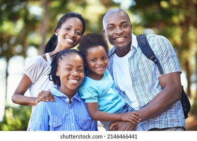 They Share A Love Of Nature. Portrait Of A Happy African American Family Enjoying A Day Out In The Forest.