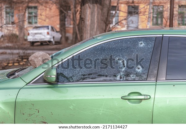 They shot at the car. Car\
gunshot marks. Holes from cartridges on glass. DNIPRO, UKRAINE –\
April 9, 2022