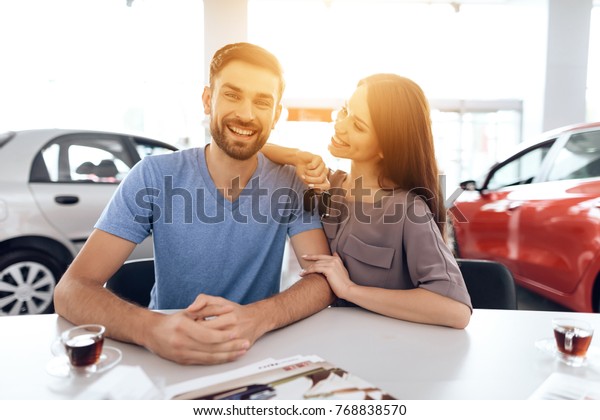 They are very happy about this, they are in\
a good mood. There are many modern\
cars.